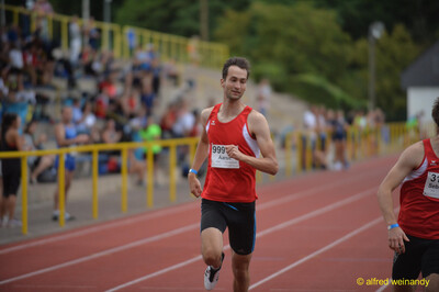 Eine Person ist mit gleichmäßigem Tempo auf der Rundbahn vor dem Publikum beim Walfried-Heinz-Sportfest der TG Konz im Saar-Mosel-Stadion in Konz unterwegs.