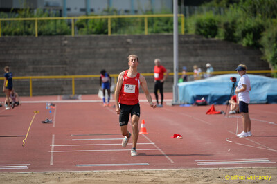 Eine Person setzt zum letzten Sprung in die Sandgrube der Dreisprunganlage an beim Walfried-Heinz-Sportfest der TG Konz im Saar-Mosel-Stadion in Konz.