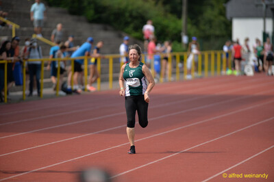 Eine Person sprintet über die Rundbahn beim Walfried-Heinz-Sportfest der TG Konz im Saar-Mosel-Stadion in Konz.