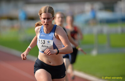 Eine Person mit der Startnummer 153 läuft konzentriert über die Rundbahn beim Walfried-Heinz-Sportfest der TG Konz im Saar-Mosel-Stadion in Konz.
