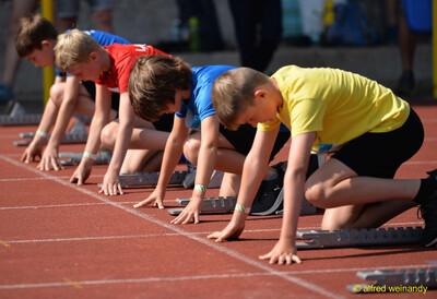 Kinder gehen an den Startblöcken in die Tiefstartposition für einen Sprint bei der Rheinland-Meisterschaft im Mehrkampf der TG Konz in Konz.