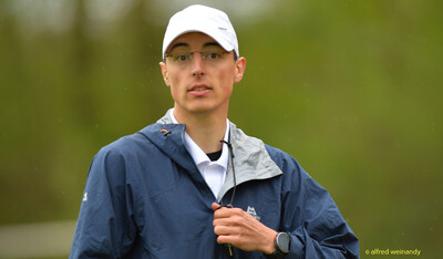 Porträt einer Person mit weißer Kappe und blauer Regenjacke beim Walfried-Heinz-Sportfest der TG Konz im Saar-Mosel-Stadion in Konz.