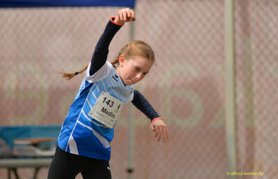Ein Kind im blau-weißen Trikot streckt bei einer schwungvollen Bewegung einen Arm nach oben beim Walfried-Heinz-Sportfest der TG Konz im Saar-Mosel-Stadion in Konz