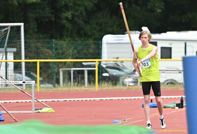 Ein Kind trägt den Sprungstab zum Anlauf beim Stabhochsprung bei der Rheinland-Meisterschaft im Mehrkampf der TG Konz in Konz.