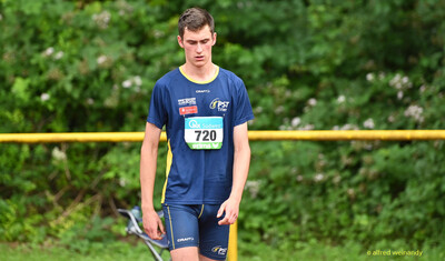 Eine Person in Wettkampfkleidung mit der Startnummer 720 geht über das Sportgelände bei der Rheinland-Meisterschaft im Mehrkampf der TG Konz in Konz.
