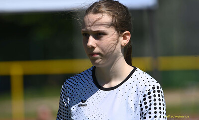 Eine jugendliche Person im weißen Trikot steht konzentriert auf der Sportanlage bei der Regionsmeisterschaft der Region Trier in Konz.