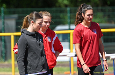 Mehrere jugendliche Aktive gehen über den Sportplatz, im Hintergrund stehen Hürden bereit, bei der Regionsmeisterschaft der Region Trier in Konz.
