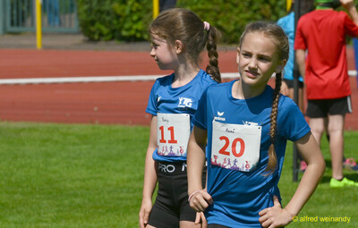 Zwei Kinder mit Startnummern stehen konzentriert am Rand der Bahn beim Kinderleichtathletik-Sportfest der TG Konz im Saar-Mosel-Stadion in Konz