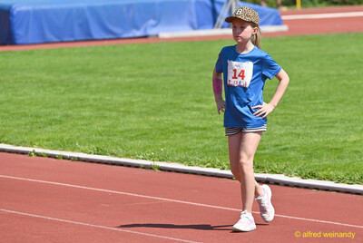 Ein Kind geht mit Startnummer über die rote Laufbahn beim Kinderleichtathletik-Sportfest der TG Konz im Saar-Mosel-Stadion in Konz